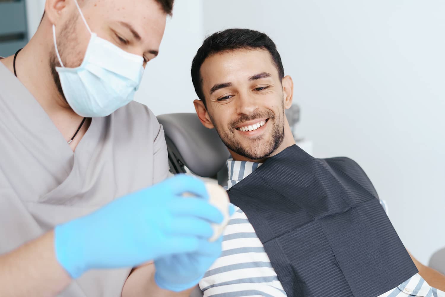 Dentist showing patient new dentures.