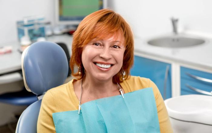 Woman smiling while at the dentist.