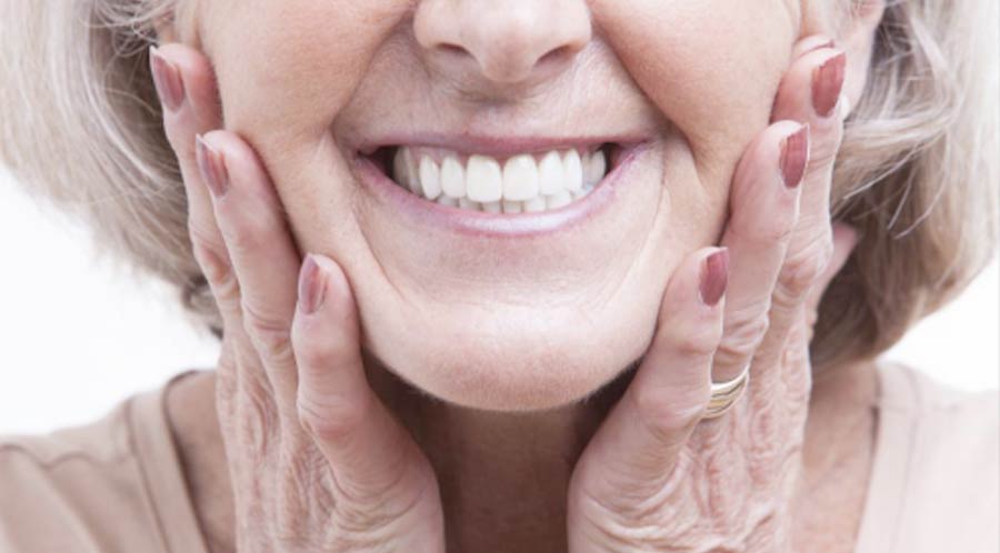Woman showing her beautiful dentures