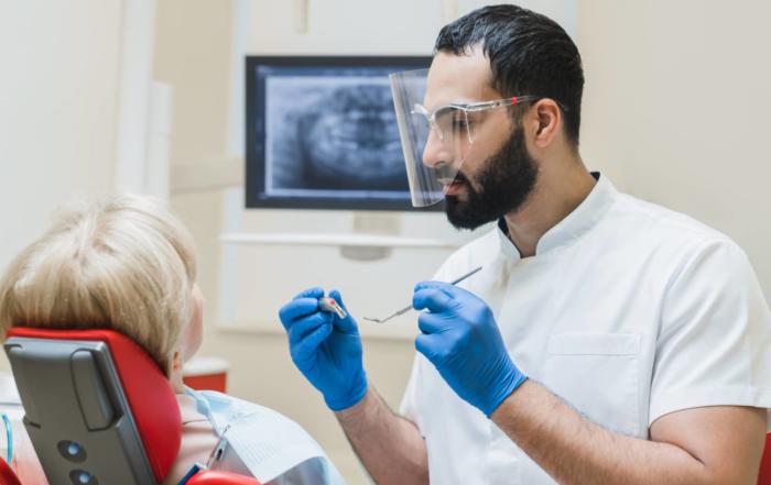 Dentist examining a patient for gum disease.